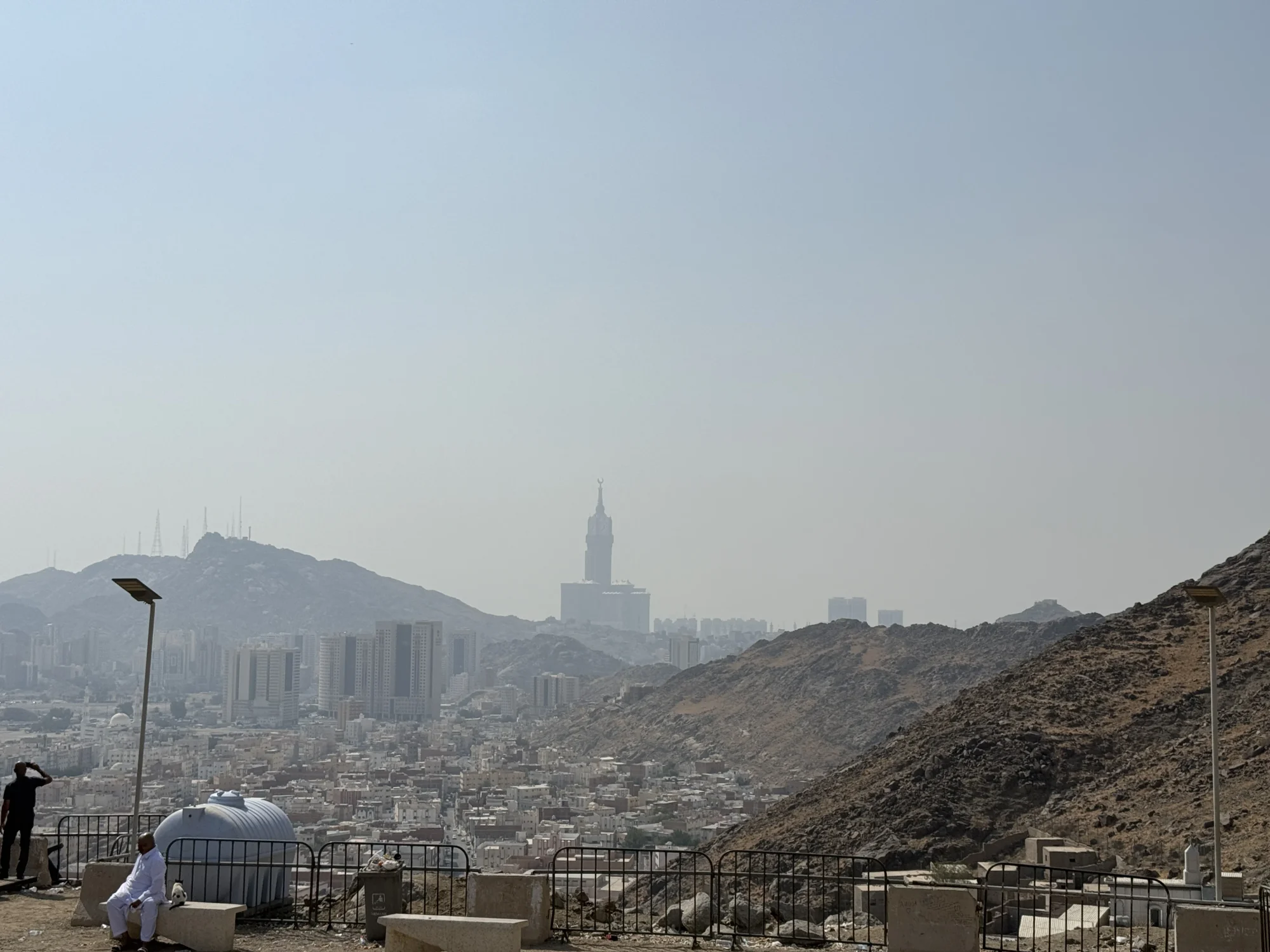 The city spread out below dry hills in the haze