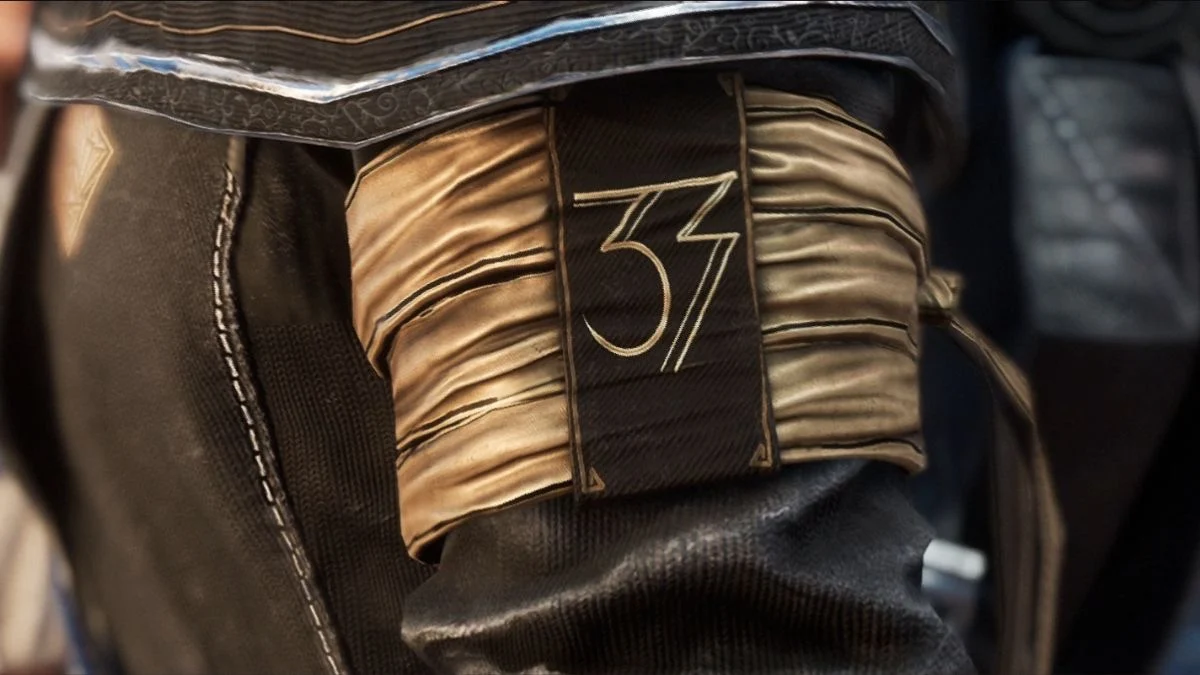 The number 33 stitched onto a sash