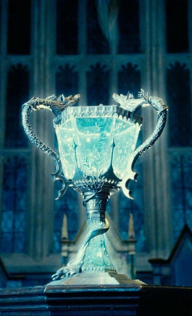 The Triwizard Cup glowing blue on its plinth