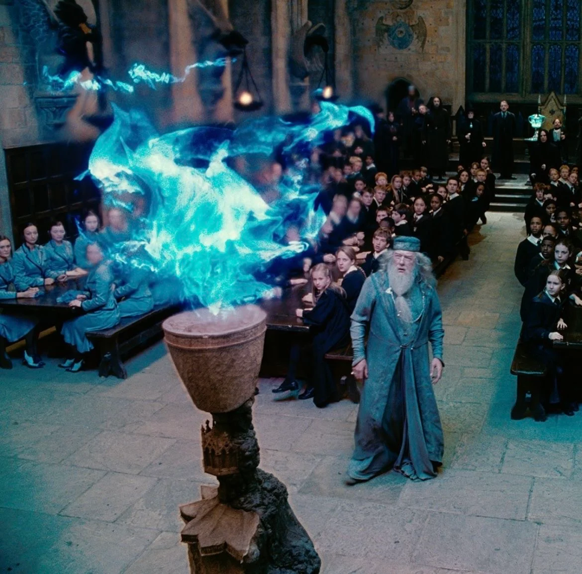 Blue fire rising from the Goblet of Fire while Dumbledore watches