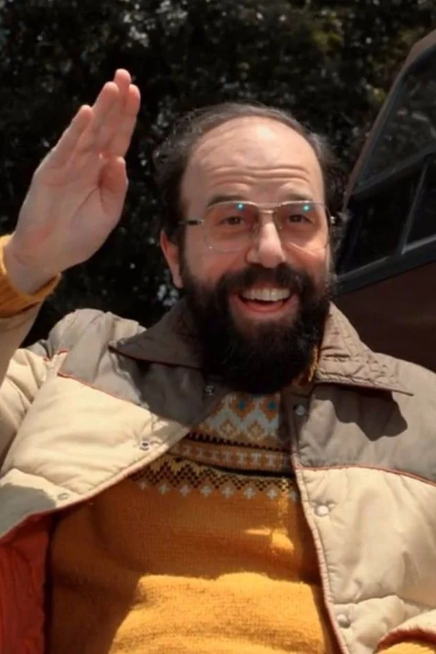 Murray Bauman waving, in a puffer jacket